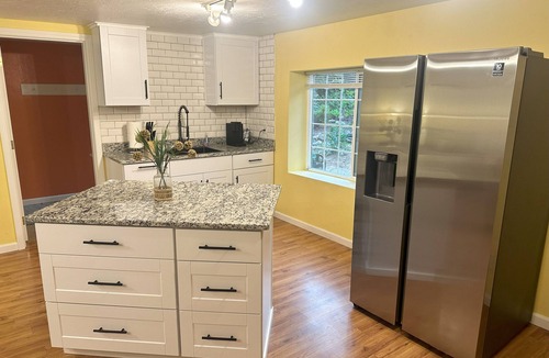 Medford House | Bring everyone together while enjoying the privacy of three separate living spaces. This unique Medford retreat features a spacious main home, two private guest homes, a seasonal pool, hot tub, fully equipped kitchens, and room for the whole family.