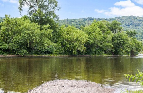 Johnson House | Caboose Tiny Home on river with hot tub near Stowe