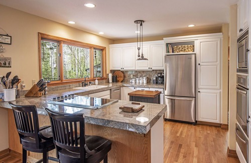 Black Butte Ranch House | GH219 | Luxury home with a private hot tub and large deck and grassy yard.