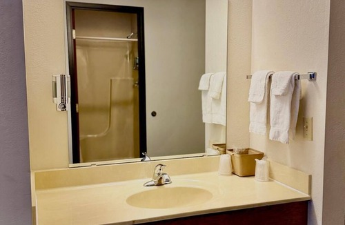 Boulder Junction Apartment | One queen bed, private bathroom with jetted tub, mini fridge, and single-serve coffee maker.