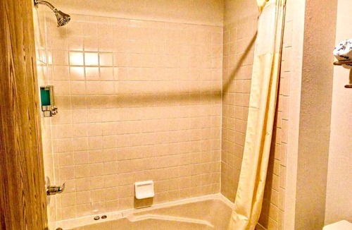 Boulder Junction Apartment | One queen bed, private bathroom with jetted tub, mini fridge, and single-serve coffee maker.