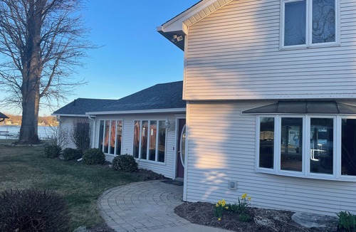 Brighton House | Spacious 4BR Lakefront Home with dock, deck, wifi, AC, & large yard in Brighton