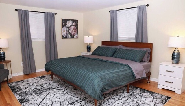 Cozy spacious 4-bedroom home nestled in wooded lot with enclosed porch