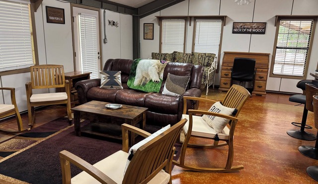 Unique camp style house with large wrap around deck.